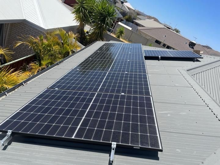 Residential solar panels with palm trees